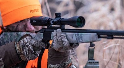Man using rifle scope