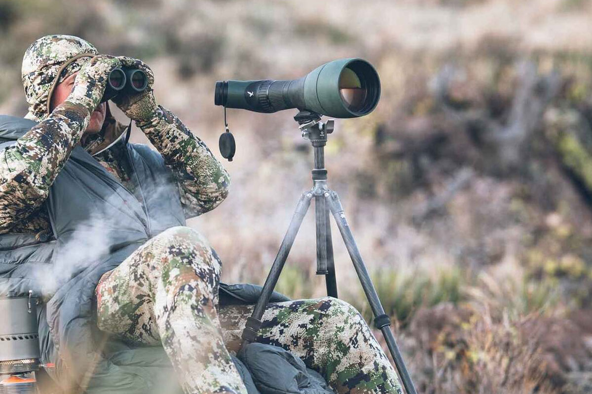 Man hunting with a spotting scope